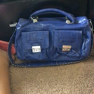 A blue Steve Madden purse , extra spacious
